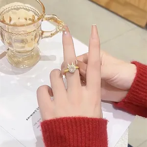 Detail of golden reindeer antler ring with sparkling white crystal on model hand