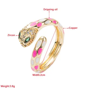 Macro detail of snake ring showing green zircon eyes and colorful dripping oil craft