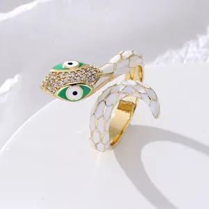 Exaggerated snake open ring with white enamel, crystal rhinestones and evil eye design