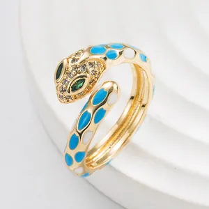 Macro shot of gold snake ring with sky blue enamel details and sparkling crystals