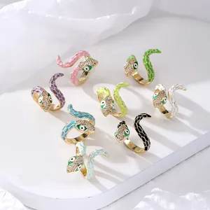 Macro detail of colorful enamel snake rings with gold plating and sparkling zircon stones