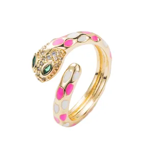 Punk style snake open ring with pink enamel spots and crystals on gold finish