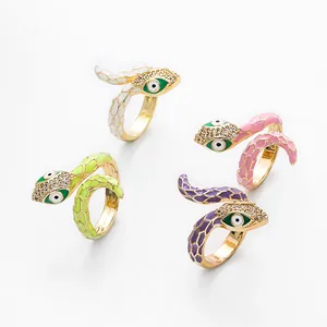 Macro detail of enamel snake rings with sparkling crystals in four vibrant colors