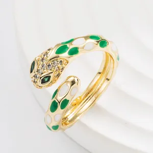 Adjustable gold punk snake ring with green enamel dots and sparkling crystal eyes