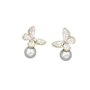 Elegant gold butterfly earrings with cat eye stones, crystals and white pearls for women