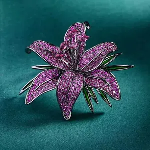 Elegant lily flower brooch with pink rhinestones and green enamel leaf accents