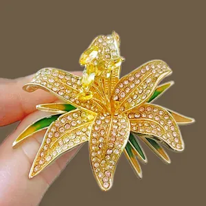 Detail of a luxury lily flower brooch with pink crystals and green enamel finish
