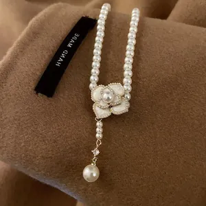 Elegant vintage camellia pearl necklace with layered flower pendant and tassel drop