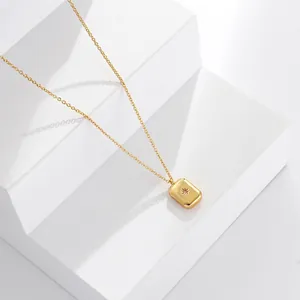 Detailed macro view of a gold starburst pendant with crystal on a fine cross chain