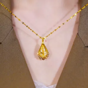 Close-up of golden filigree teardrop necklace on a model wearing a brown blazer