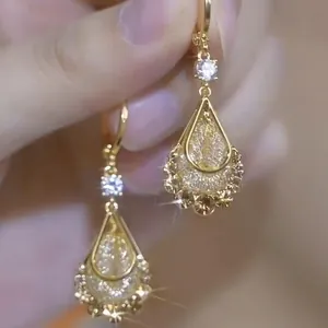 Elegant gold drop earrings with crystal teardrop pendants and sparkling zircon accents