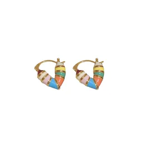 Colorful enamel heart-shaped earrings with gold metal frame on a white background