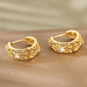 Vintage golden hollow engraved hoop earrings with cubic zirconia in a classic design