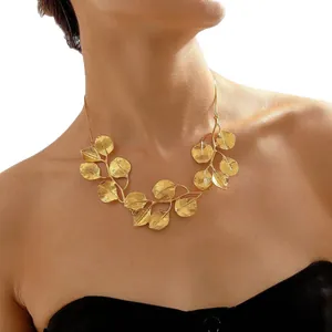 Elegant gold-plated leaf necklace with snake chain for women, shown on a collarbone