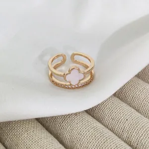 Double-layered rose gold ring featuring a white clover motif and sparkling zircon stones