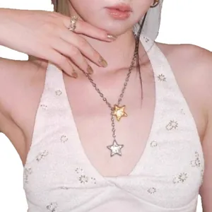 Silver chain necklace with double gold and zircon star pendants worn by a model