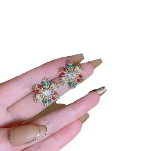 Sparkling Christmas snowflake stud earrings with colorful crystals in gold-plated settings