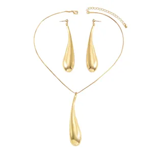 Golden minimalist jewelry set featuring elegant teardrop necklace and matching earrings