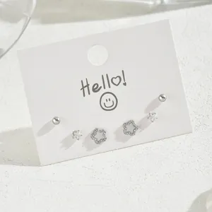 Minimalist silver stud earrings set featuring star and floral designs with zircons
