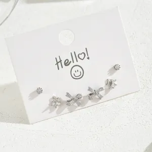 Silver star and bow cubic zirconia stud earring set of three pairs on white card display