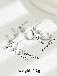 Detailed view of silver star and moon earrings set featuring sparkling zircon stones