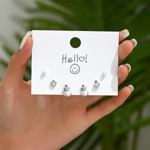 Set di tre paia di orecchini a perno con perle e zirconi a cuore su cartoncino