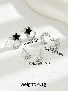 Detail view of silver stud earring set with stars, moon designs and size measurements