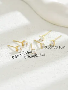 Macro shot showing dimensions of gold stud earrings with cubic zirconia in various sizes