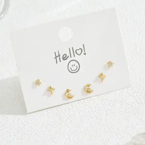Set of 3 pairs golden star and moon stud earrings with zircon on a white display card