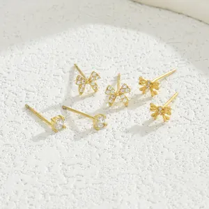 Elegant gold S925 silver stud earrings set featuring bow designs and sparkling zircons