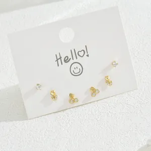 Detailed set of six gold stud earrings featuring tulip, cherry, and zircon designs