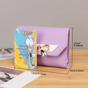 Detail view of purple tri-fold wallet with bow charm and 12cm x 9cm dimensions