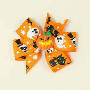 Halloween orange ribbon bow hair clip featuring pumpkin face and spooky ghost patterns