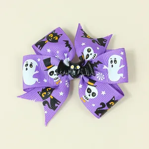 Macro shot of a purple Halloween bow hair clip featuring a black bat and spooky ghost prints