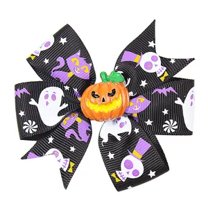 Detail of Halloween bow hair clip featuring ghost prints and an orange pumpkin charm