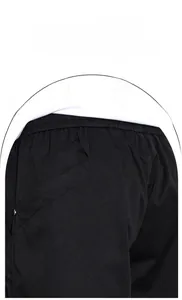 Detail of black cargo pants showing elastic waistband stitching and side pocket design