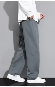 Close-up of men's gray wide-leg cargo pants with straight cut and premium drape fabric