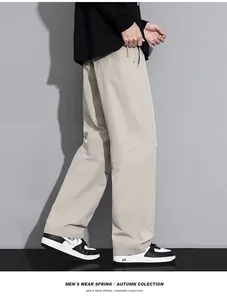Side view of men's loose beige cargo pants with straight leg cut and casual style