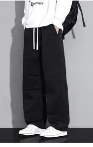 Detail of black cargo pants featuring white drawstring and pleated knee stitching accents