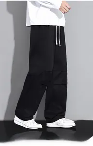Detail of men's casual cargo pants featuring elastic drawstring waist and seam stitching