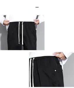 Detail of men cargo pants showing elastic waistband with white drawstring and side pockets