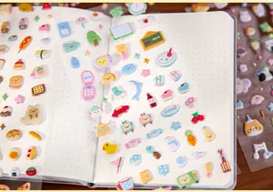 Detailed macro view of various cute and colorful puffy foam stickers on a journal page.