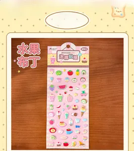 Detailed view of colorful fruit and dessert themed puffy stickers for scrapbooking