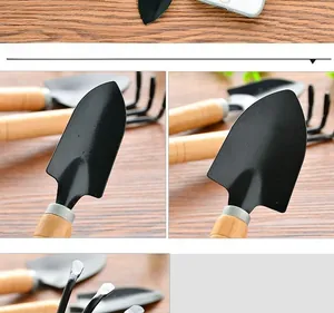 Detail view of gardening trowel with black metal head and smooth wooden handle
