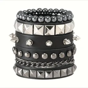 Detail of 4-piece punk bracelet set featuring black leather straps and silver metal studs