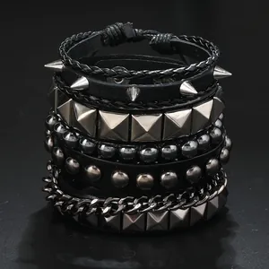 Detail of 4-piece punk bracelet set featuring silver spikes, rivets, and black leather cords