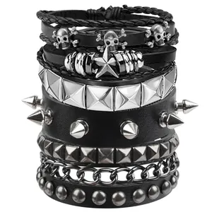 Close-up of gothic punk bracelets featuring silver skulls, star charms and metal spikes