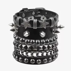 Detailed close-up of six punk rock black leather bracelets with silver spikes and metal studs