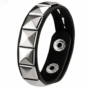 Detail of punk leather bracelet with silver pyramid studs and double snap closure