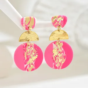 Three-tier acrylic drop earrings with magenta marble patterns and gold leaf accents